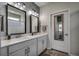 Modern bathroom with a double sink vanity, decorative mirrors, lights, and neutral accents at 5406 Longhorn Dr., Myrtle Beach, SC 29588