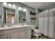 Well-lit bathroom with double sinks, white cabinets, a shower, and tasteful decor, designed for comfort at 5406 Longhorn Dr., Myrtle Beach, SC 29588