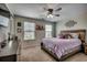 Cozy bedroom featuring a comfortable bed, two bright windows, and a ceiling fan, creating a relaxing space at 5406 Longhorn Dr., Myrtle Beach, SC 29588