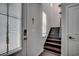 Inviting entryway featuring a staircase, natural light, and modern door lock at 5406 Longhorn Dr., Myrtle Beach, SC 29588