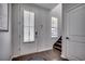 Bright foyer featuring a white door, hardwood floors, and staircase leading to upper level at 5406 Longhorn Dr., Myrtle Beach, SC 29588
