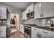 Modern kitchen with white cabinets, granite countertops, and stainless steel gas range at 5406 Longhorn Dr., Myrtle Beach, SC 29588