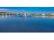 A tranquil lake view with a fountain, surrounded by homes and a clear blue sky at 5406 Longhorn Dr., Myrtle Beach, SC 29588