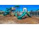 Vibrant community playground featuring slides and climbing structures, set against a backdrop of a clear blue sky at 5406 Longhorn Dr., Myrtle Beach, SC 29588