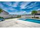 Inviting backyard pool featuring a sun shelf and mature landscaping, designed for luxurious relaxation at 5406 Longhorn Dr., Myrtle Beach, SC 29588