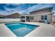 Backyard pool area featuring a sun shelf, surrounded by well-kept landscaping and the home's exterior, great for entertaining at 5406 Longhorn Dr., Myrtle Beach, SC 29588