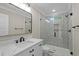 This bathroom has a marble-look vanity, black fixtures, a glass-enclosed shower with mosaic tile, and a modern mirror at 6001 - 1793 S Kings Hwy., Myrtle Beach, SC 29575
