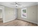 This bedroom features wood-look floors, neutral walls, white trim and doors, plus a bright window and modern ceiling fan at 6001 - 1793 S Kings Hwy., Myrtle Beach, SC 29575