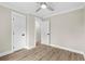 The bedroom is equipped with wood-look flooring, neutral walls, white trim and doors, plus a modern ceiling fan with light at 6001 - 1793 S Kings Hwy., Myrtle Beach, SC 29575