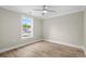 This room features wood-look flooring, neutral walls, white trim, and a window looking out onto trees and a neighboring home at 6001 - 1793 S Kings Hwy., Myrtle Beach, SC 29575