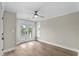 This bright bedroom features wood-look floors, neutral walls, and a ceiling fan, with doors to a small balcony with a view at 6001 - 1793 S Kings Hwy., Myrtle Beach, SC 29575