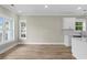 Open-concept kitchen area featuring hardwood floors, modern white cabinetry, and natural lighting at 6001 - 1793 S Kings Hwy., Myrtle Beach, SC 29575
