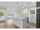 Kitchen island featuring marble countertop, wood floors, with view of the living room at 6001 - 1793 S Kings Hwy., Myrtle Beach, SC 29575