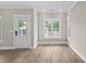 Bright living room featuring hardwood floors, white trim, and large windows for ample natural light at 6001 - 1793 S Kings Hwy., Myrtle Beach, SC 29575