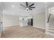 Open-concept living room featuring wood floors, ceiling fan, white trim and eat-in kitchen with stainless appliances at 6001 - 1793 S Kings Hwy., Myrtle Beach, SC 29575