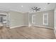 A spacious living room featuring wood floors, neutral color walls, white trim, ceiling fan and staircase at 6001 - 1793 S Kings Hwy., Myrtle Beach, SC 29575