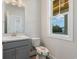 Bathroom with vanity, toilet, mirror and window with a view of the outdoors at 61 Yale Pl., Pawleys Island, SC 29585