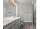 Bathroom with double vanity, gray cabinets, a glass shower and hardwood floors at 61 Yale Pl., Pawleys Island, SC 29585