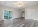Spacious bedroom with wood floors, ceiling fan, and sliding glass door leading to outdoor space at 61 Yale Pl., Pawleys Island, SC 29585