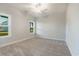 Carpeted bedroom with bright natural light coming from two windows and a ceiling fan at 61 Yale Pl., Pawleys Island, SC 29585