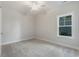 Bright, carpeted bedroom with a ceiling fan and a window that lets in natural light at 61 Yale Pl., Pawleys Island, SC 29585