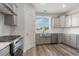 Modern kitchen with stainless steel appliances, gray cabinets and a farmhouse sink at 61 Yale Pl., Pawleys Island, SC 29585