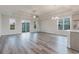 Spacious living room with hardwood floors, a tray ceiling, and lots of natural light at 61 Yale Pl., Pawleys Island, SC 29585