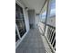 Residential balcony with a small table and railing, offering neighborhood views and a tiled floor at 6103 N Ocean Blvd. # C-6, North Myrtle Beach, SC 29582
