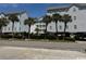 Condos featuring neatly landscaped grounds and mature palm trees on a clear sunny day at 6103 N Ocean Blvd. # C-6, North Myrtle Beach, SC 29582