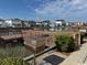 Community grilling area with a stainless steel grill near the water with waterfront homes visible at 6103 N Ocean Blvd. # C-6, North Myrtle Beach, SC 29582