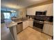 Modern kitchen featuring stainless steel appliances, white cabinets, and stylish granite countertops at 6103 N Ocean Blvd. # C-6, North Myrtle Beach, SC 29582