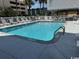 Community swimming pool surrounded by white fencing and lounge chairs on a sunny day at 6103 N Ocean Blvd. # C-6, North Myrtle Beach, SC 29582