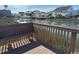 Peaceful water view of a canal from a wooden bench on a deck overlooking waterfront homes at 6103 N Ocean Blvd. # C-6, North Myrtle Beach, SC 29582