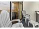 Condo balcony with chairs, small table, and views through the sliding glass doors to the living area at 6804 N Ocean Blvd. # 829, Myrtle Beach, SC 29572