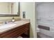 Well-maintained bathroom with vanity, mirror, and access to a clean, updated shower area, and toilet at 6804 N Ocean Blvd. # 829, Myrtle Beach, SC 29572