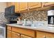 Functional kitchen featuring stainless steel sink, countertop appliances, and ample cabinet space and tile backsplash at 6804 N Ocean Blvd. # 829, Myrtle Beach, SC 29572