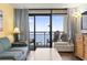 Comfortable living area leading to a balcony offering beautiful ocean views at 6804 N Ocean Blvd. # 829, Myrtle Beach, SC 29572