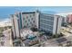 Elevated aerial view of a beachfront building, oceanfront access, and surrounding parking area at 7100 N Ocean Blvd. # 320, Myrtle Beach, SC 29572