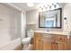 Bright bathroom featuring a shower-tub combo, vanity with granite countertop, and a large framed mirror at 7100 N Ocean Blvd. # 320, Myrtle Beach, SC 29572