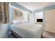 Comfortable bedroom featuring a queen bed, light blue walls, and a wall-mounted television at 7100 N Ocean Blvd. # 320, Myrtle Beach, SC 29572