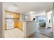 Well-lit kitchen with wood cabinets and modern appliances opens up to the condo's living room at 7100 N Ocean Blvd. # 320, Myrtle Beach, SC 29572
