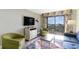 Comfortable living area with balcony access, television, and seating; enjoy the scenic views at 7100 N Ocean Blvd. # 320, Myrtle Beach, SC 29572