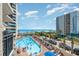 Overhead view of a pool with palm trees, beach, and the ocean in the background at 7100 N Ocean Blvd. # 320, Myrtle Beach, SC 29572
