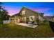 Beautiful backyard at twilight with a swing and screened-in porch at 736 Flowering Branch Ave., Little River, SC 29566