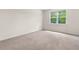 Carpeted bedroom with a window and neutral paint at 736 Flowering Branch Ave., Little River, SC 29566