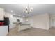 Open concept kitchen, island and an adjacent living area with recessed lighting at 736 Flowering Branch Ave., Little River, SC 29566