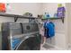 Laundry room with front loading washer and dryer, shelving and storage space at 736 Flowering Branch Ave., Little River, SC 29566
