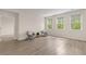 Sitting room with wood-look floors, three windows, and neutral paint at 736 Flowering Branch Ave., Little River, SC 29566
