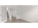 Bright living room with neutral walls, wood floors, and glass paned double doors leading to a stairway at 736 Flowering Branch Ave., Little River, SC 29566