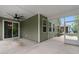 Relaxing screened porch with ceiling fan and view to an outdoor area at 736 Flowering Branch Ave., Little River, SC 29566